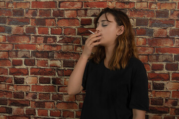 Fototapeta na wymiar Young depressed girl smoking cigarette.