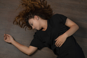 Young addicted girl laying on the ground