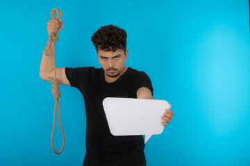 Young man holding rope and idea board