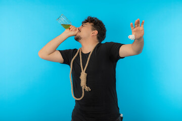 Young boy with rope. Man drinking alcohol on blue background