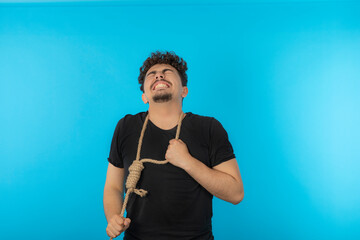 Young man crying and stretching rope. Young man trying to suicide