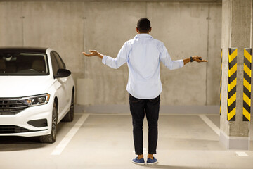 The African American man found his car missing. . Car theft concept.