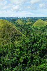 Fototapeta na wymiar Bohol, Philippines - July 2022: The Chocolate Hills are a geological formation in Bohol Island on July 3, 2022 in Bohol, Philippines.
