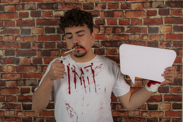 Young man light his cigarette and holding white idea board