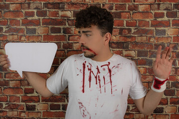Injured young man holding idea board and feeling exhausted