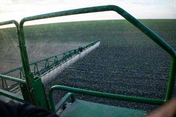 A special tractor sprays the fields from weeds, spraying the fields close-up.
