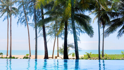 Outdoors blue pool at beach in luxury hotel or resort in Thailand in hot sunny summer day....
