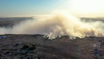 Aerial view of burning garbage piles in trash landfill