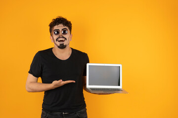Smiling happy man wears sunglasses and holding computer