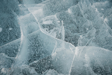 Melting ice. Cracks in the ice of Lake Storsjö. Global warming concept. Beautiful conceptual blue...