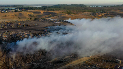 Aerial view of burning garbage piles in trash landfill