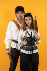 Couple Pirates holding guns and looking at the camera.