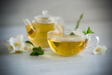 Composition with cup of jasmine tea and flowers