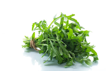 bunch of fresh organic green arugula on white background