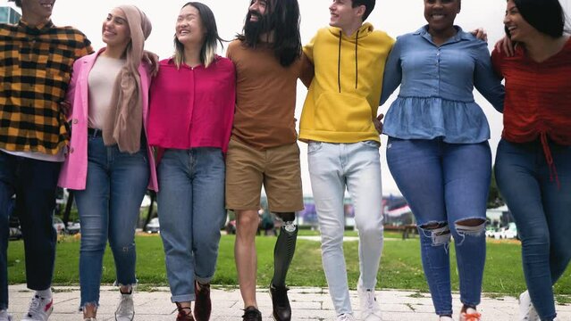 Group of young multiracial friends having fun hanging out together in the city - Friendship and diversity concept