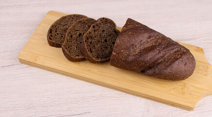 Sliced black bread on a cutting board