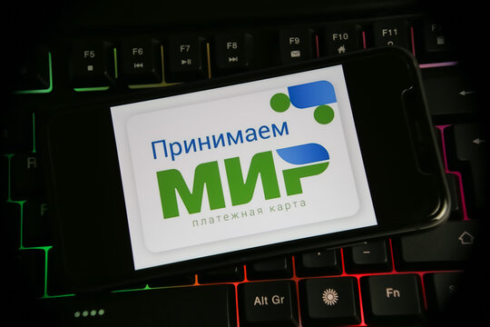 Viersen, Germany - July 9. 2022: Closeup Of Mobile Phone Screen On Computer Keyboard With Logo Lettering Of MIR (MNP) Russian World Payment System