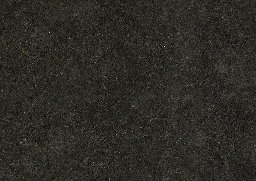 High resolution highly detailed large image of an paperboard carton uncoated paper texture background black with large rough grain fiber and white dust particles wallpaper with copy space for text
