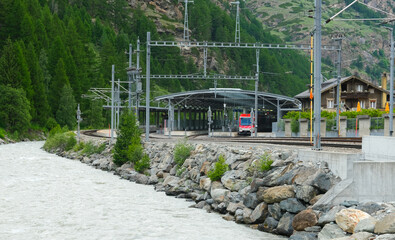 A picture of train terminal, pole, tree and river insight at Tasch Village.