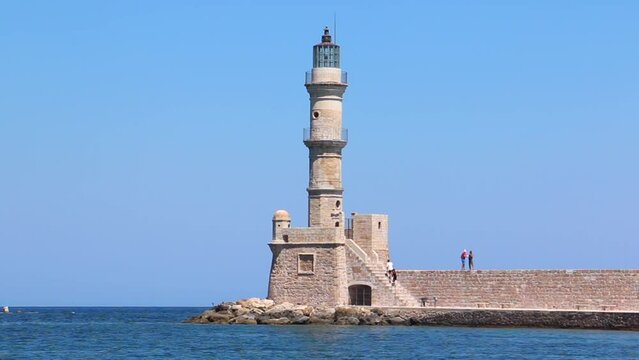 Chania, Crete - old lighthouse in city center harbor, sunny day