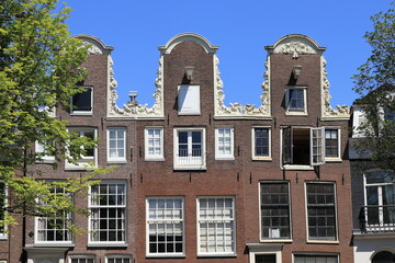 Fototapeta na wymiar Amsterdam Prinsengracht Canal Historic House Facades with Neck Gables Close Up, Netherlands