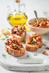 Tasty and fresh toasts with chanterelles, parmesan cheese and herbs.
