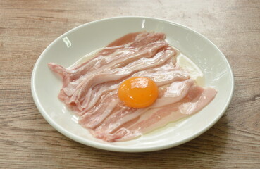 raw slice pork belly arranging topping egg on plate