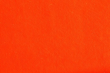 Abstract design halloween holiday background of glossy artificial genuine textured orange creased leather. Flat surface. Skin natural wrinkled scratched wallpaper pattern. Close-up, mock up, top view