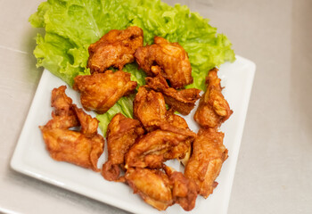 Serving chicken to bird on a dish just leaving the kitchen