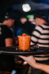 Special drink with passion fruit and strawberry ready to be served to the customer