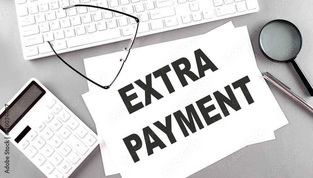Poster extra payment text on paper with keyboard, calculator on grey background