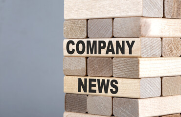The text on the wooden blocks COMPANY NEWS