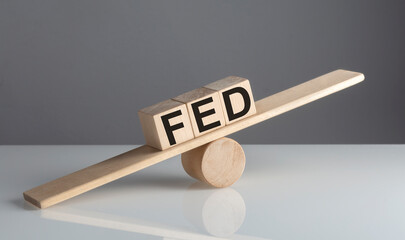 FED on wooden cubes on wooden balance , business concept