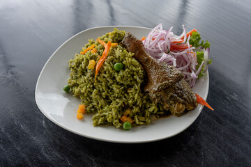 Peruvian food, rice with duck, accompanied by onion and lettuce. Top view.