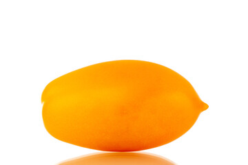 One ripe yellow tomato, close-up, isolated on a white background.