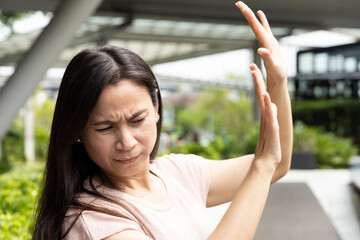 Middle age woman afraid of sunlight, sun tan, sun burn, concept image of beauty, facial care or...