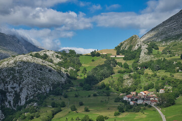 Fototapeta premium Picturesque town of houses with stone facades located on the mountain top of the Picos de Europa in a rural setting.