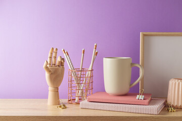 Stylish feminine workspace with coffee cup, notebook and pencils over purple background. Back to school concept