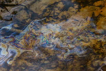 oil spills on puddle background, abstract gasoline nature pollution concept