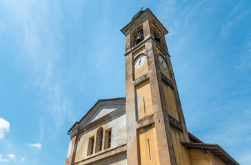 Fototapeta na wymiar The bell tower of the old church of Saint Antnio Abate in the small ancient village Naggio, province of Como, Lombardy, Italy
