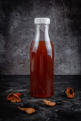 Fruity morsels, juice from dried fruits on a dark background. Cool drinks for cafe menu. Fast food restaurant, delivery service.