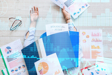 Double exposure of virtual screen with diagrams and tired businesswoman with lot of documentations lying on floor in office