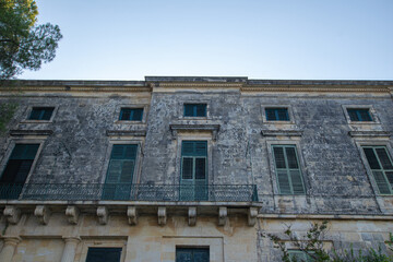 Fototapeta na wymiar Old traditional venetian blinds on old wall at Kerkyra town in Corfu Greece