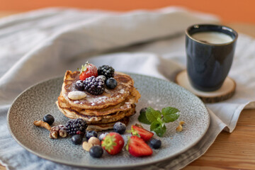 Sugar dusted pancakes with fruit and mint