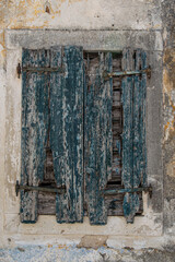 Green rotten wooden window at old abandoned traditional house at Corfu Greece