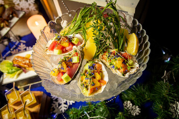 Fototapeta na wymiar Tuna ceviche in a shell on the festive table