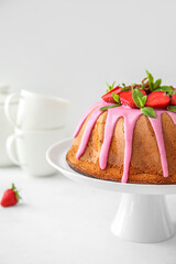 Dessert stand with tasty strawberry cake on light background