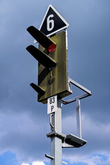 red railway signal at rail track