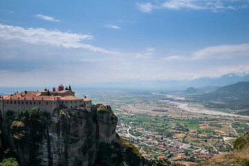 Fototapeta na wymiar View of a Orthodox monastery and Kalabaka town from the top of the iconic rocks of Meteora in Greece