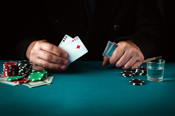 A professional player in a poker club shows the winning combination in one pair cards. Success or...